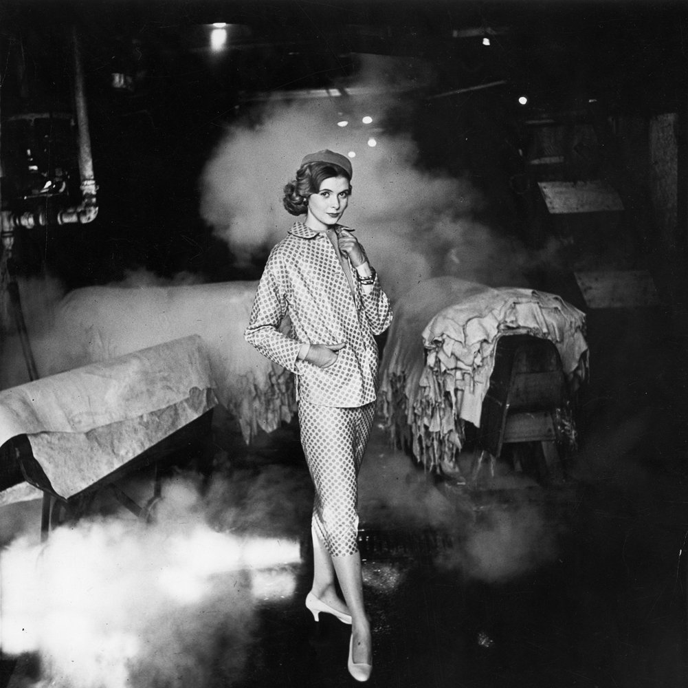 French fashion model Simone Bodin posing at tannery in leather suit printed in small neat design.